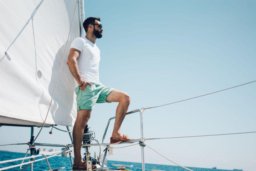 A man sailing on the boat he purchased with a credit union vehicle loan.